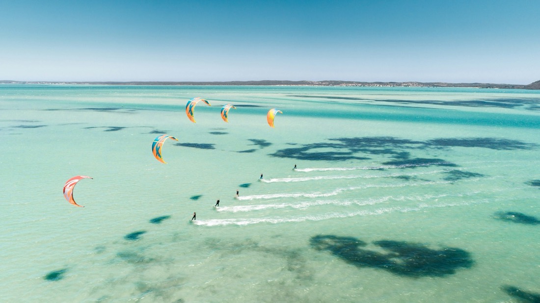 Kites over a turquoise lagoon