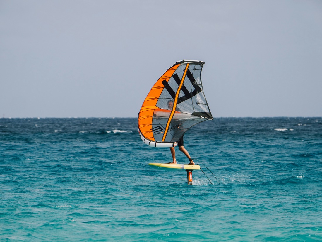 Wing foiler on blue water