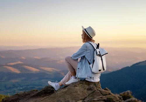 a-girl-with-a-backpack-in-the-mountains-tourism-and-adventure.jpg